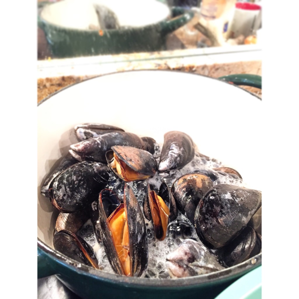 Steam the mussels in the white wine until they open up and smile at you!